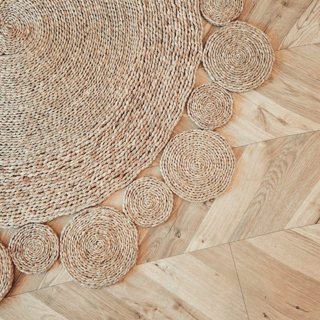 Natural-fibre jute rug layered in a modern, airy living space.