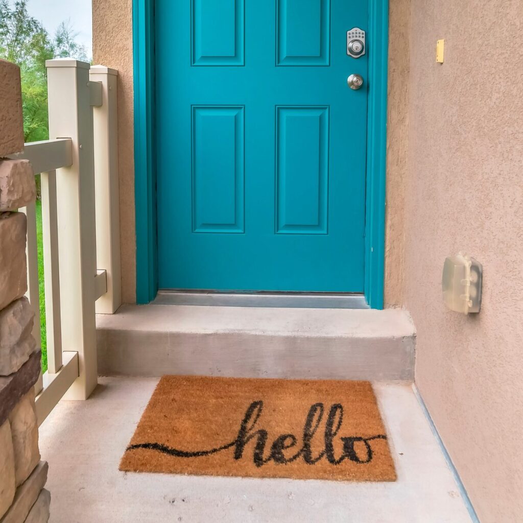 Colourful doormat with a sunny greeting at the front door.