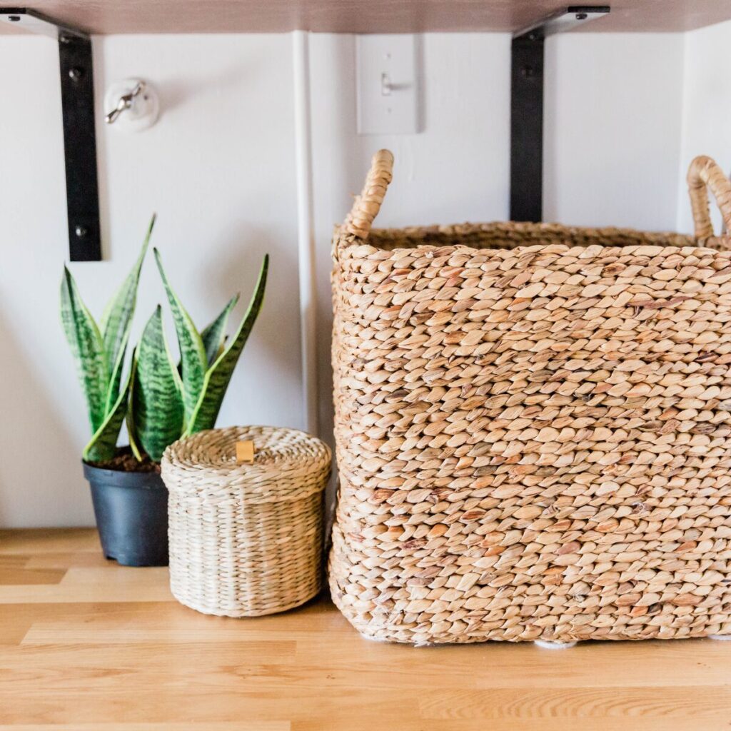 Wicker and cane home decor accents on display in a summer-themed room.