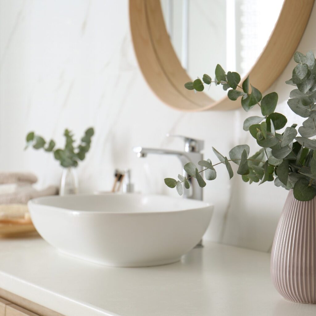 Spa-style bathroom with bath tray, white towels, and natural touches.