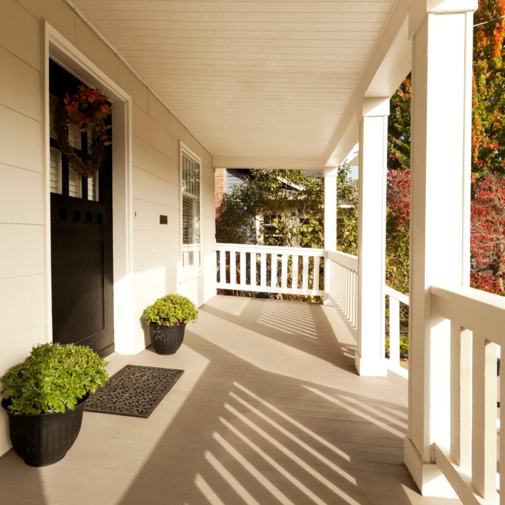 Lanterns and plants styled to refresh a summer-ready entryway or porch.